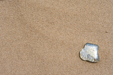 Fototapeta na wymiar Colored stones in the background of sand