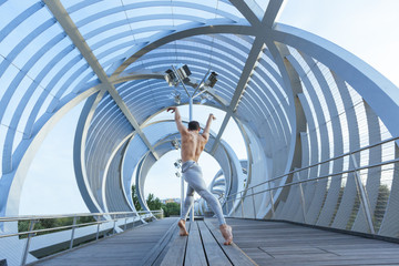 geometric perspective of a barefoot male dancer performing a ballet pose