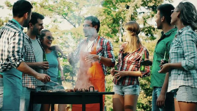 Young people grilling outdoors