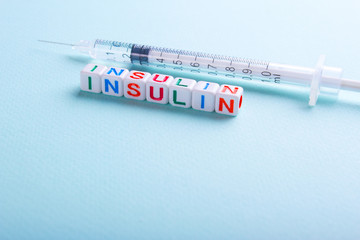 Insulin syringe on a green background
