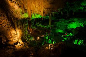 Beautiful illuminated multicolored cave and stalactites from karst Prometheus Cave. Georgia