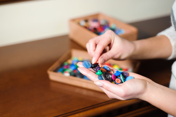colorful sewing buttons in the hands
