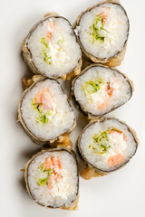 six delicious sushi rolls from above isolated on gray background