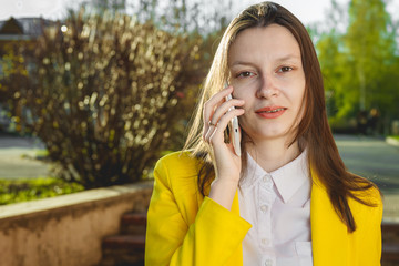 Attractive woman using cellphone outdoors.