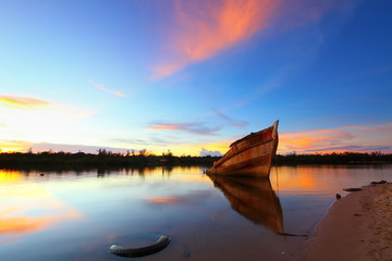 Abandoned ship at sunset