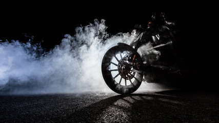 High power motorcycle chopper with man rider at night - obrazy, fototapety, plakaty
