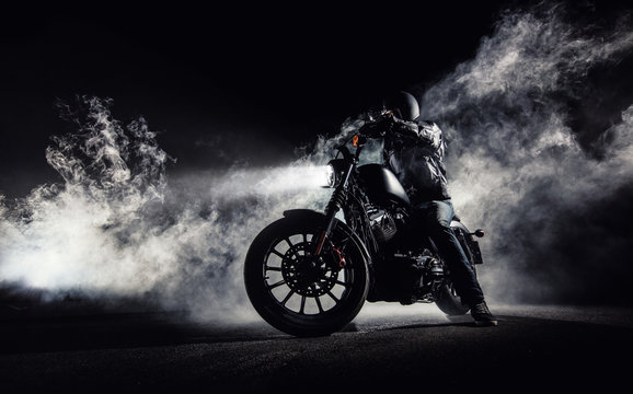 Fototapeta High power motorcycle chopper with man rider at night