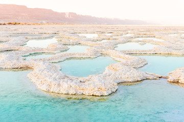 View of Dead Sea coastline. Salt crystals at sunset. Texture of Dead sea. Salty sea shore