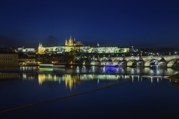Fototapeta na wymiar Prague Castle and Charles Bridge at night, blue sky and river, Czech republic