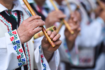 Fototapeta na wymiar People singing at traditional wooden flutes