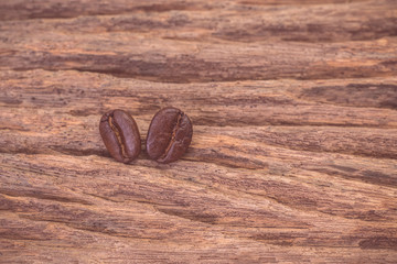 Roasted coffee beans on wood texture background. vintage color effected