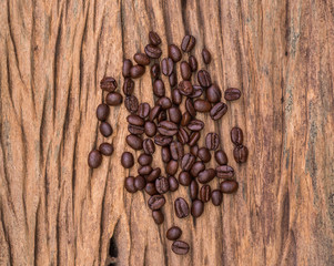 Roasted coffee beans on wood texture background