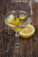 dirty martini chilled and garnished with a lemon twist on wooden table
