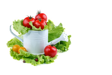 Yellow and red tomatoes lie in basket on a white background.