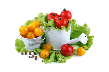 Yellow and red tomatoes lie in basket on a white background.