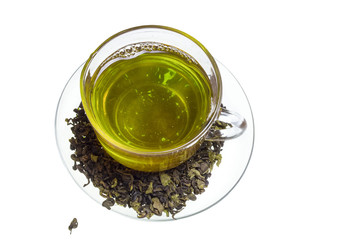 Glass mug of pure green natural tea with tea leaves