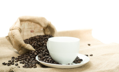 Coffee cup and coffee beans on  a canvas bag