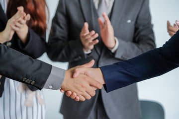 Group of business people meeting shaking hands together, business outdoor meeting concept.