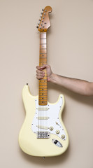 Obraz premium Hand Holding White Vintage Electric Guitar