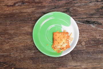 cookies bread square  in the plate on old wooden floor background