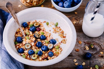 Healthy breakfast: oat granola with yogurt,  fresh blueberries and pumpkin seeds