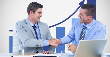Business people shaking hands against graph