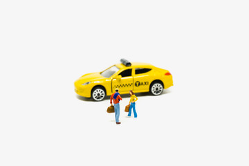 Miniature people man and woman waiting taxi isolated on white background
