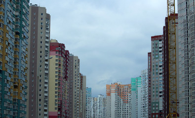 Colored multi-story houses in line on the city street