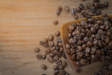 coffee beans isolated on wood background.