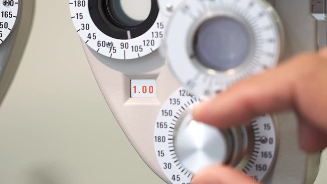 Closeup view of eyecare gradation machine with man right hand