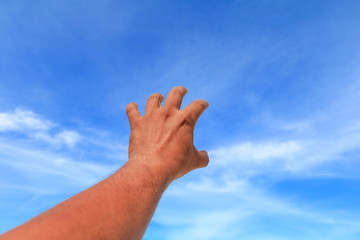 hand reach up blue sky background