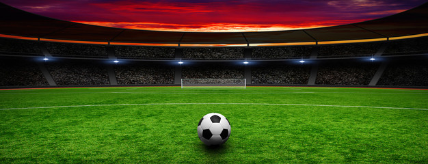 Soccer ball on green stadium