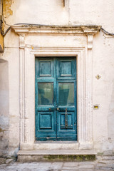 Fototapeta na wymiar Turquoise italian door to old house