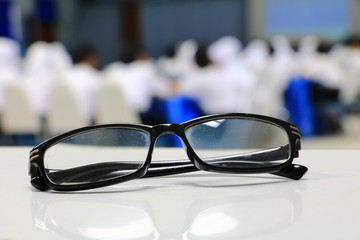 eyeglasses old or spectacles of teacher on the table in seminar conference classroom: Select focus with shallow depth of field.