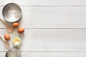 Baking ingredients on white rustic wood background, copy space