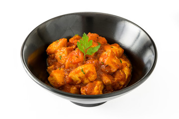 Chicken tikka masala in bowl isolated on white background

