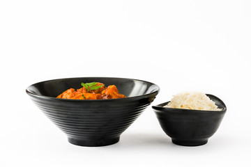 Chicken tikka masala and rice in bowl isolated on white background

