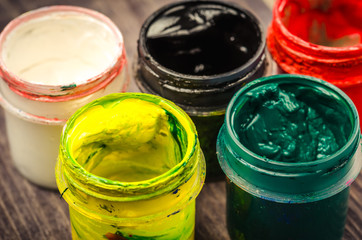 opened jars with multi colored paint/opened jars with paint