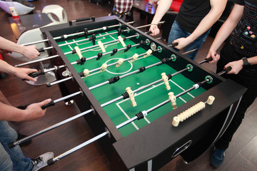 People playing table football. Detail.