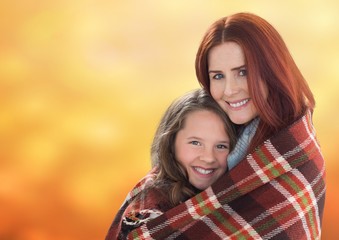 Obraz premium Mother hugging daughter against background