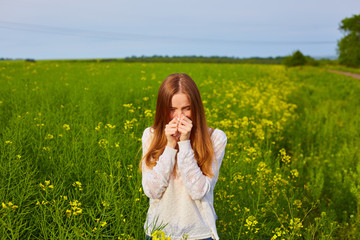 Young delightful female among field