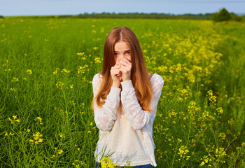 Young delightful female among field