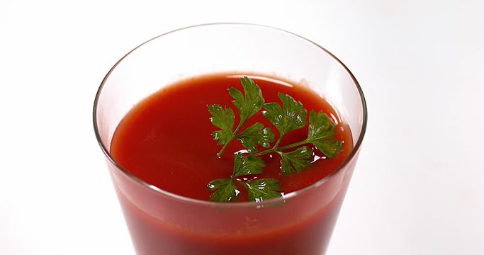 Parsley, Petroselinum crispum, falling into tomatoe's Juice, Slow Motion 4K