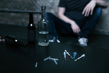 Various bottles and syringes lying on the table in the darkness
