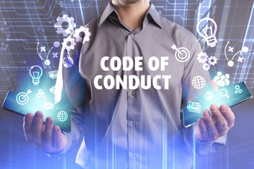 Business, Technology, Internet and network concept. Young businessman working on a virtual screen of the future and sees the inscription: Code of conduct