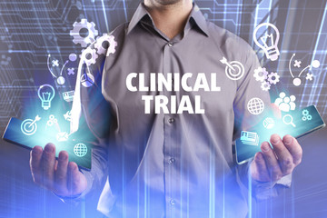 Business, Technology, Internet and network concept. Young businessman working on a virtual screen of the future and sees the inscription: Clinical trial