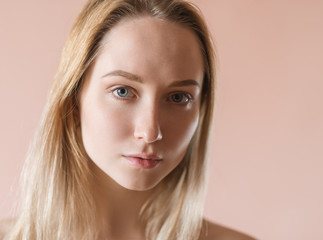 Portrait of a beautiful young woman with blue eyes.