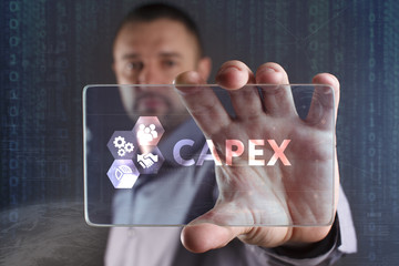 Business, Technology, Internet and network concept. Young businessman working on a virtual screen of the future and sees the inscription: Capex