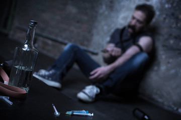 Homeless drug addict having heroin injection on the street - obrazy, fototapety, plakaty