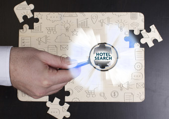 Business, Technology, Internet and network concept. Young businessman shows the word: Hotel search